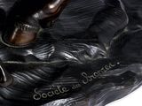 statue of a man riding a horse on a black base