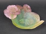 purple and green glass flower on a leaf shaped dish