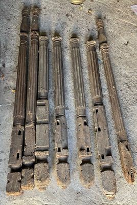 four old wooden pipes sitting on the floor next to a coin