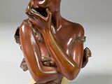 statue of a woman holding her hand to her chin