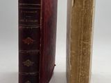two old books sitting side by side on a white surface