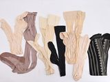 many different types of clothing on a white surface