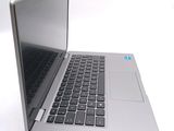 a silver laptop with a black keyboard on a white surface