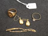 two gold rings, a bracelet, a ring, and a bracelet with a tag