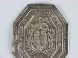 an old silver coin with a picture of a castle on it