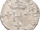 a silver coin with a crown on top of it