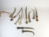 several different types of knifes are displayed on a white surface