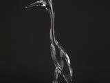 a clear glass bird sitting on top of a rock