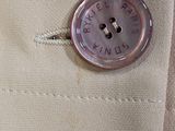 a button that is on the back of a jacket