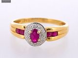 an image of a gold ring with a ruby and diamond center