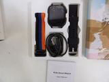 a box with a watch and other items in it