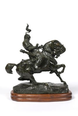 bronze statue of a man on a horse with a bird on its back