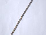 a close up of a metal stick on a white surface