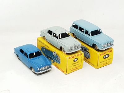 three toy cars are sitting on top of boxes on a white surface