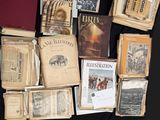 many old books on the table with pictures on them
