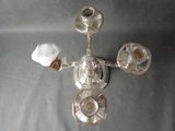 a glass candle holder with three candles on it