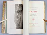 an open book with a picture of a city in it
