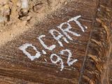 a close up of a wooden bench with writing on it