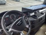 steering wheel of a truck with a laptop on the dashboard