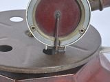 a red and silver object on a white surface