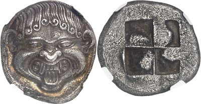 an image of a silver coin with a face and a cross on it