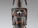 an image of a wooden statue of a woman holding a baby