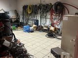 a room with a lot of wires and a refrigerator