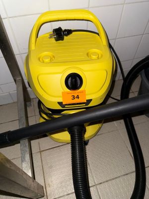 a yellow blow dryer sitting on the floor next to a black hose