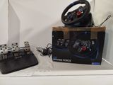 a box with a steering wheel and a game controller on it