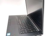 a laptop computer that is open on a white surface