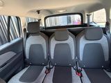four seats in the back of a car with a rear view mirror