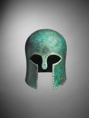 a bronze helmet on a gray background