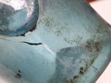 a close up of a blue vase on a table