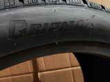 a close up of a tire on a box with a cardboard box in the background