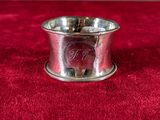 a close up of a silver cup on a red cloth