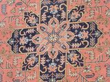 an antique persian rug with a blue and pink design