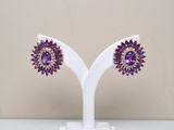 pair of amethorate and goldtone earrings on a white stand