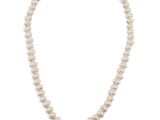 a white pearl necklace with a gold clasp on a white background