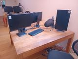 a desk with two computer monitors and a keyboard on it