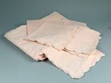 a pile of pink handkerchiefs on a blue surface