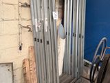 a metal door that is open on the side of a building