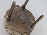 a close up of a metal object on a white surface