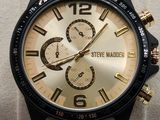 a close up of a watch on display on a stand