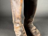 an old pair of boots with a brown leather sole