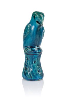 a blue vase with a bird on it on a white surface