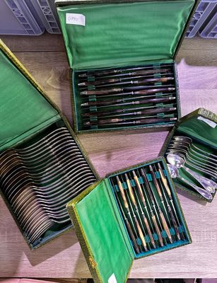 a lot of different colored pencils in a green case