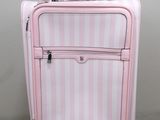 a pink suitcase that is sitting on the floor