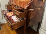 a wooden desk with a drawer on top of it