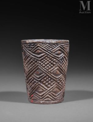 a close up of a cup on a table with a black background