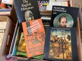 many books that are in a box on the floor